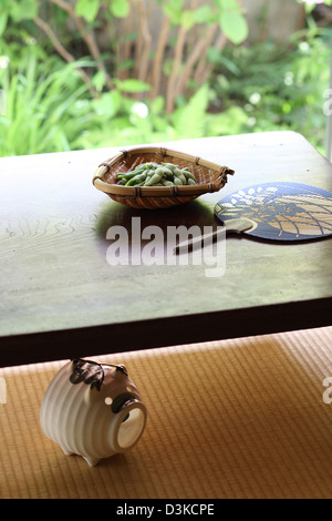 Soybeans and paper fan on a wooden table Stock Photo