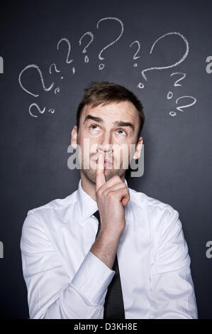 young handsome confused businessman with chalk drawn Stock Photo