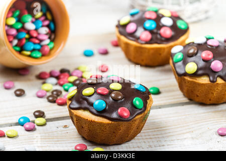 Decorating easter muffins with candies Stock Photo