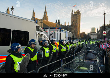 Police line in full riot gear guarding the Houses of Parliament, Day X3 Student Demonstration, London, England Stock Photo