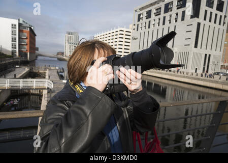 Lady photographer with camera. Stock Photo