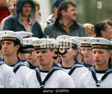 (dpa) - The picture shows 290 marines pledge allegiance to the German flag during stormy weather in Bremerhaven, Germany, Thursday, 11 August 2005. The public swearing-in ceremony took place on the occasion of the '50 Jahre Bundeswehr' celebration in conjunction with the international tall ship meeting 'Sail 2005' from 09 August to 14 August 2005. Photo: Ingo Wagner Stock Photo