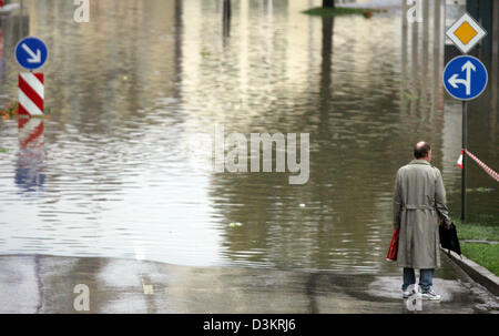(dpa) - A man faces a water flooded parking lot in Bad Toelz, Germany, 23 August 2005. Continous rain at the foothills of the Alps forced rivers to rise drastically. In several regions red alert was issued. The citizens of Bad Toelz hope that the Isar river recedes to normal level. Photo: Matthias Schrader Stock Photo