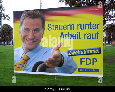 (dpa) - Guido Westerwelle, chairman of the Liberal Democratic Party (FDP) is featured on an election poster, which reads ' Tax down jobs up. Second vote for FDP' pictured ahead of the general elections for the German Bundestag parliament on 18 September 2005, in the state of North Rhine Westphalia, Germany on 27 August 2005. Photo: Wolfgang Moucha