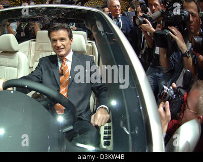 (dpa) - The picture shows Volkswagen brand chairman Wolfgang Bernhard at the steering wheel of VW's new 'EOS' surrounded by photographers at the 61st International Motor Show (IAA) in Frankfurt Main, Germany, Monday 12 September 2005. The IAA is the world most comprehensive automobile show of the whole industry with almost 1.000 exhibitors from 44 countries. The fair's organisers e Stock Photo