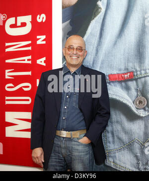 (dpa file) - Heiner Sefranek, CEO of clothing retailer Mustang, stands smiling in front of an advertising poster of the denim brand Mustang at the company's headquarter in Kuenzelsau, Germany, 06 April 2005. Photo: Harry Melchert Stock Photo