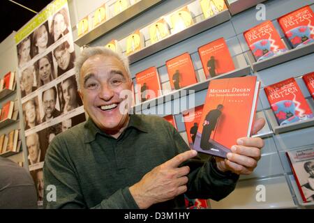 (dpa) - German actor and writer Michael Degen smiles as he points at his new novel 'The tax evader' at the international book fair in Frankfurt, Germany, 20 October 2005. Photo: Uwe Zucchi Stock Photo
