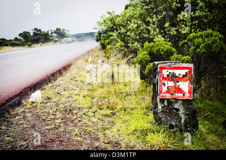 A warning sign on the road to Piton de la Fournaise volcano, French Reunion Island, Indian Ocean Stock Photo