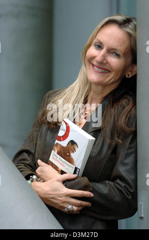 (dpa) - German author Gaby Hauptmann holds a copy of her new book 'Yachtfieber' (yacht fever) in her hands, pictured at the international book fair in Frankfurt, Germany, 21 October 2005. Photo:Jan Woitas Stock Photo