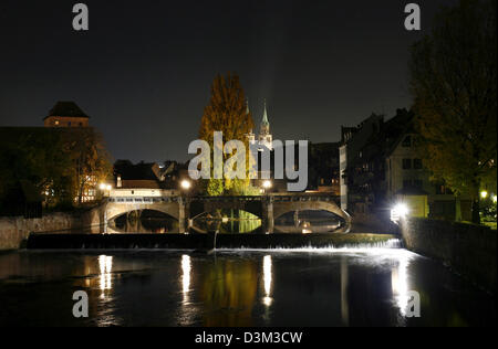 (dpa) - The picture shows the nocturnal view over the Pegnitz river on the Max bridge in Nuremberg, Germany, 26 October 2005. In the center background the pinnacles of the Lorenz church can be seen. Photo: Daniel Karmann Stock Photo