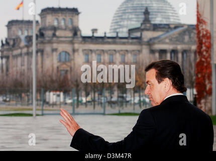 (dpa) - German Chancellor Gerhard Schroeder stands in front of a backdrop of the Reichstag, the building which is home to the German parliament, as he awaits the arrival of Chinese President and party leader Hu Jintao at the chancellery in Berlin, Friday 11 November 2005. Hu Jintao's visit marks the final official visit of a foreign guest for Chancellor Schroeder during his term in Stock Photo