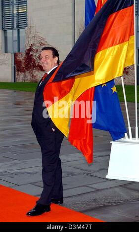 (dpa) - German Chancellor Gerhard Schroeder stands in front of swaying flags as he awaits the arrival of Chinese President and party leader Hu Jintao at the chancellery in Berlin, Friday 11 November 2005. Hu Jintao's visit marks the final official visit of a foreign guest for Chancellor Schroeder during his term in office. Photo: Jens Buettner Stock Photo