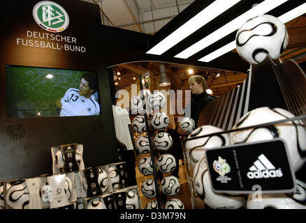 (dpa) - A boy looks at official balls for the 2006 FIFA Soccer World Cup in Germany while on a TV screen can be seen Michael Ballack, captain of the German national soccer team, at the Karstadt Game and Sports store in Berlin, Germany, 12 December 2005. The official ball is on sale for 110 euros starting today. A replica version, which is also offered by sporting goods company adid Stock Photo