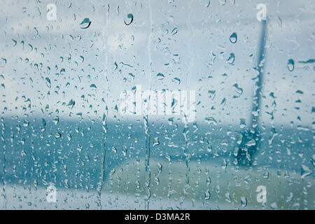 View of raindrops running down the window on a catamaran during monsoon off the northern coast of Mauritius. Stock Photo