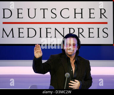 Bono, frontman of Irish rock band 'U2' gestures during a press conference at the convention centre in Baden-Baden, Germany, Tuesday, 24 January 2006. Bono (45) received the German Media Prize. He was awarded for his humanitarian committment in particular to the problems in Africa. The award, which was established by the company Media Control in 1992, honours personalities who have  Stock Photo