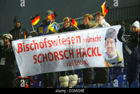 German Fans German cheer for triple gold medal winner Georg Hackl smiles during his second run at the Olympic luge track in Cesana Pariol, Italy, Saturday 11 February 2006. Taking fifth place after two of four runs his sixth Olympic medal lies still within reach. Italian gold favourite Armin Zoeggler clocked fastest time. Photo: Arne Dedert Stock Photo