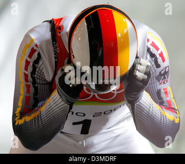 German triple gold medal winner Georg Hackl takes of his helmet after his second run at the Olympic luge track in Cesana Pariol, Italy, Saturday 11 February 2006. Taking fifth place after two of four runs his sixth Olympic medal lies still within reach. Italian gold favourite Armin Zoeggler clocked fastest time. Photo: Arne Dedert Stock Photo