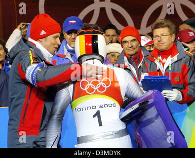 German luger Georg Hackl (R) is pictured with national luge coach Thomas Schwab (L) after his fourth and last run at the Olympic luge track in Cesana Pariol, Italy, Sunday 12 February 2006.The triple Olympic gold medal winner ended his career 7th placed in the Olympic luge competition Photo: Arne Dedert Stock Photo
