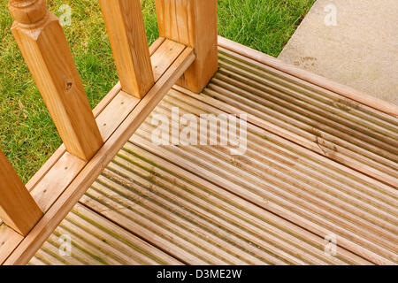 Corner profile of wooden garden decking a popular feature outside modern homes Stock Photo