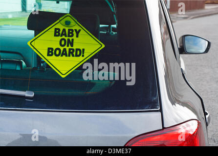 Baby on board warning sign in the back window of a car to advise cars behind of the presence of a toddler Stock Photo