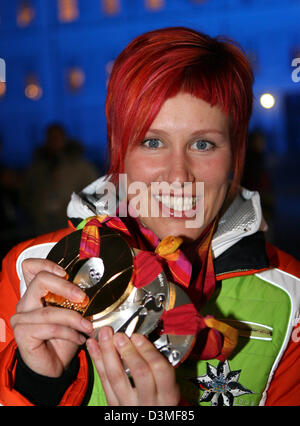 (dpa) - German biathlete Kati Wilhelm presents one gold and two silver medals after the presentation ceremony at the Medals Plaza in Torino, Italy, 25 February 2006. Photo: Martin Schutt Stock Photo