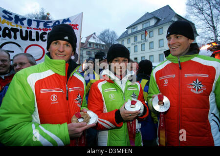 Olympic medal winners in Nordic Combined (from L) Georg Hettich, Jens Gaiser (R) and cross-country skier Stefanie Boehler present their medals and smile during a reception in Schonach, Germany, Monday, 27 February 2006. All three athletes from the state of Baden-Wuerttemberg were welcomed with a celebration in the spa garden of Schonach. Around 6,000 spectators arrived for the rece Stock Photo