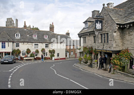 The Dorset village of Corfe Castle, with the castle itself peeping out over the rooftops. Stock Photo