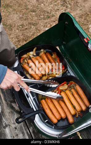 Cooking bratwurst on a gas camp stove on The White River, Cotter Arkansas Stock Photo