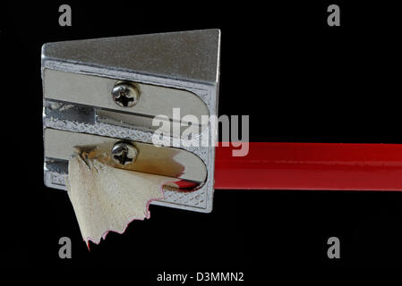 Red pencil being sharpened in close up Stock Photo