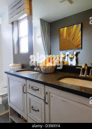 Kids bathroom with yellow ducks decor and white cabinets. Stock Photo