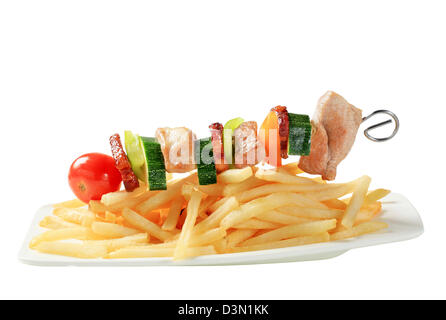 Pork and vegeable skewer with French fries Stock Photo