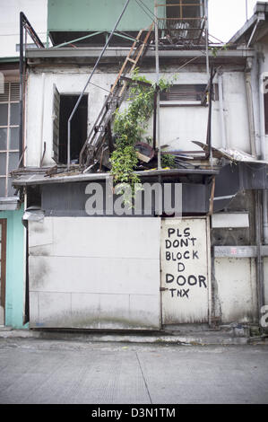 Run Down Building with parking sign Stock Photo