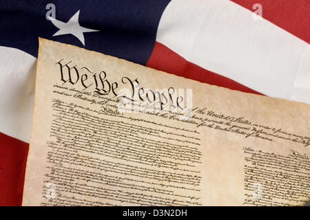 US Constitution against an american flag. Stock Photo