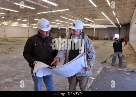 Orange, CT USA-- Bryan, left, and his father, Frank Bowser look over plans for the Crunch Fitness club they are developing. Stock Photo