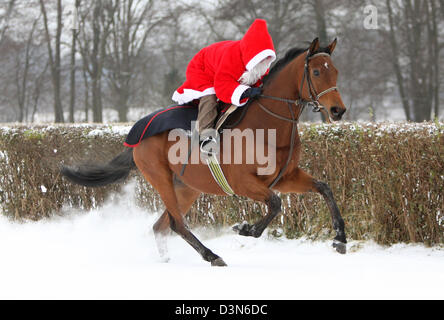 Hoppegarten, Germany, Santa Claus riding on a horse through the snow Stock Photo