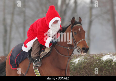 Hoppegarten, Germany, Santa Claus riding on a horse Stock Photo