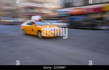 A new hybrid model medallion yellow taxi cab in New York City (blur for motion) Stock Photo