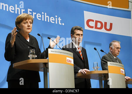 German Chancellor Angela Merkel (L) speaks and Wolfgang Boehmer (R), Prime Minister of Saxony-Anhalt, and Guenther Oettinger (C), Prime Minister of Baden-Wuerttemberg, listen at the press conference on the board meeting of the Christian Democratic Union (CDU) party in Berlin, Germany, Monday, 27 March 2006. The CDU analysed the situation after elections in the Federal State parliam Stock Photo