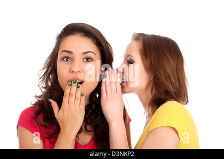 Two women whispering and smiling Stock Photo