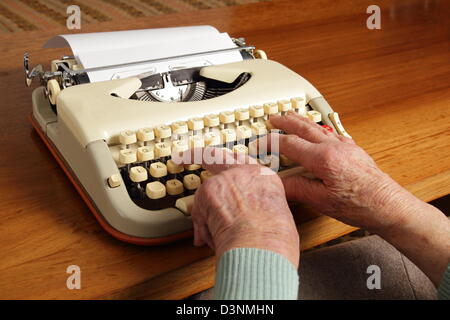 Grandma writing with an old typewriter Stock Photo
