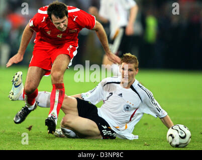 German national soccer player Bastian Schweinsteiger vies with Maciej Zurawski from Poland during the group A match of 2006 FIFA World Cup between Germany and Poland in Dortmund, Germany, Wednesday, 14 June 2006. Photo: Roland Weihrauch+++ Mobile Services OUT +++ Please refer to FIFA's Terms and Conditions Stock Photo