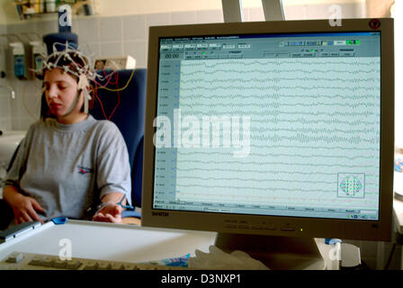 A patient undergoes an EEG in a neurologist surgery in Iserlohn, Germany, 30 August 2005. The electroencephalography (EEG) examines the elctric activity of the brain by electrodes. Brainwaves, tiny natural electric potential variations, get measured, enhanced and displayed on paper or a computer. The EEG has remained indispensable in the diagnostic of epilepsy. But for other cerebr Stock Photo