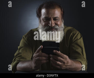 Man reading a text message on a mobile phone Stock Photo