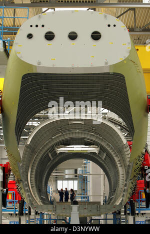 Workers of the Airbus plant carry out detail works during the assembly of the body segments for the first military A400M airbus in Bremen, Germany, Monday 24 July 2006. With the handing over of a new production hall and the start of the assembling of the body the final production of the A400M military transporter starts off. The final assembly will be concluded in the Spanish airbu Stock Photo