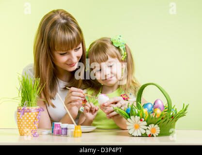 mother and daughter kid painting easter eggs Stock Photo