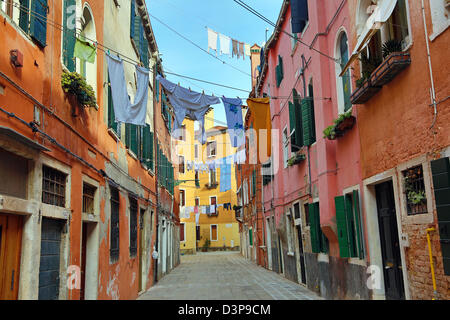 Drying clothes hanging out to dry on a washing line across a street on washday in Venice, Italy Stock Photo