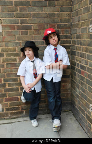 Two brothers hanging out in the street. Stock Photo