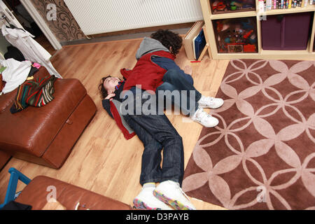 Two young brothers fighting indoors. Stock Photo