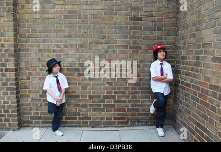 Two brothers hanging out in the street. Stock Photo