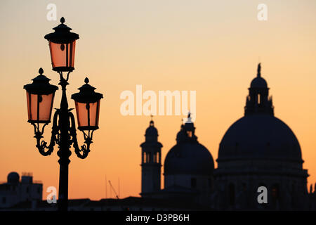 Silhouette of Santa Maria Della Salute and a lamp post at sunset in Venice, Italy Stock Photo